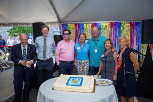 Distinguished guests gather around 50th birthday cake