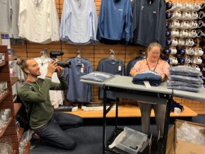 Allison folding spiritwear at Yale bookstore