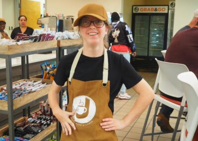 Gillian with apron and cap working at Cafe J